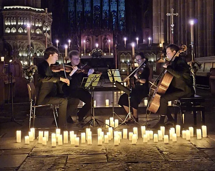 String Quartet playing music by The Beatles lit by candlelight at St Mary's Church, Nantwich